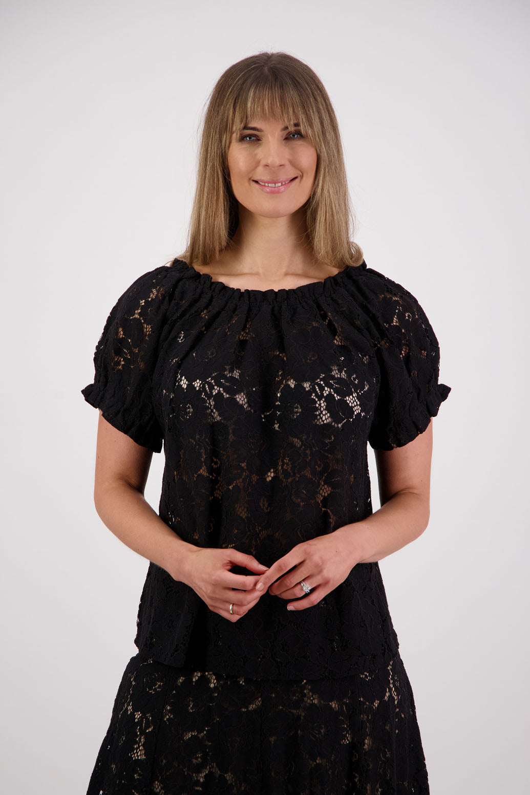 Womens black lace top with short sleeves elasticated neck and sleeves with slight ruffle. Briarwood NZ. Serenity Black