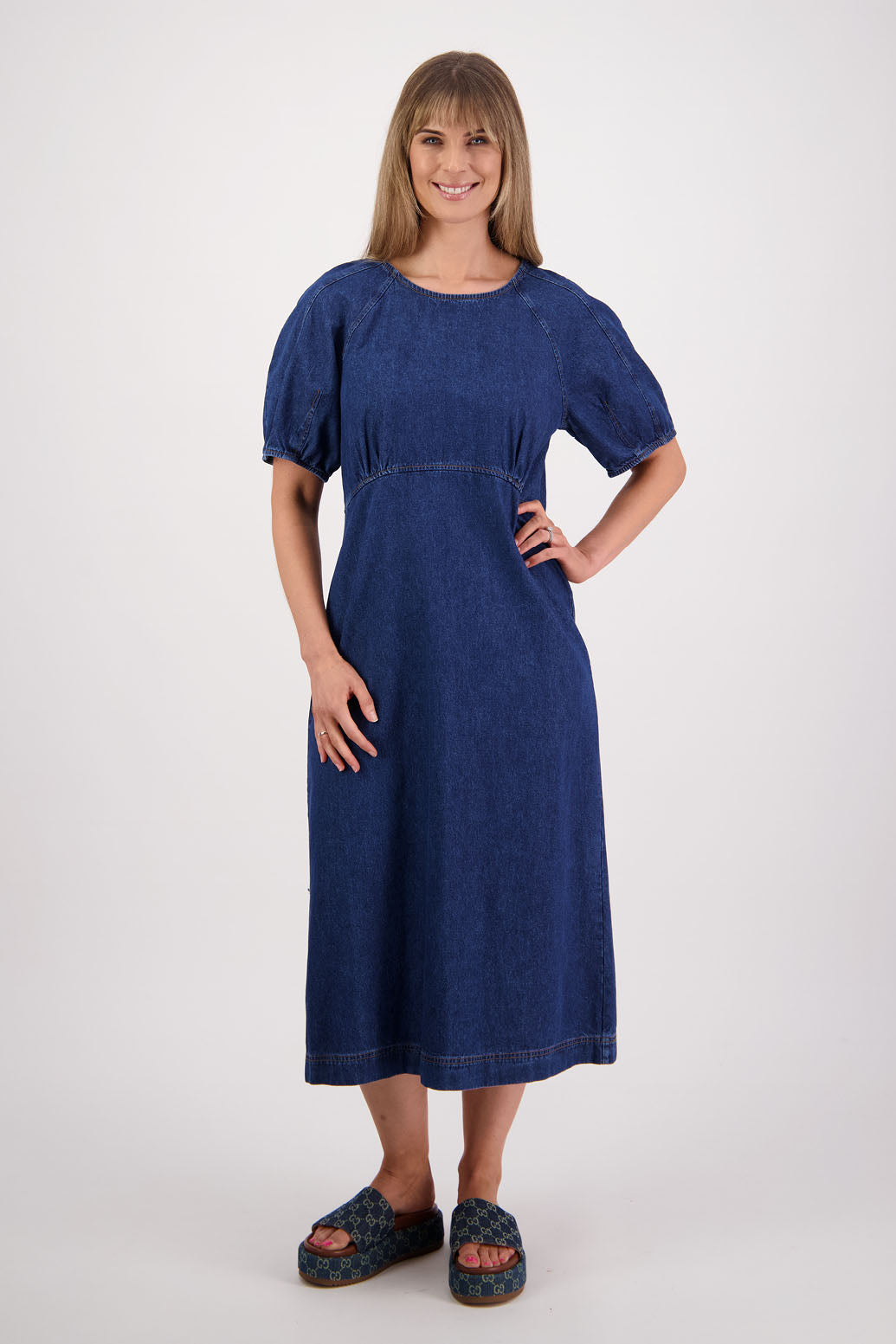 Womens denim dress, slim fitting body, curved empire line bodice and slight puff in panelled sleeves. Briarwood NZ
