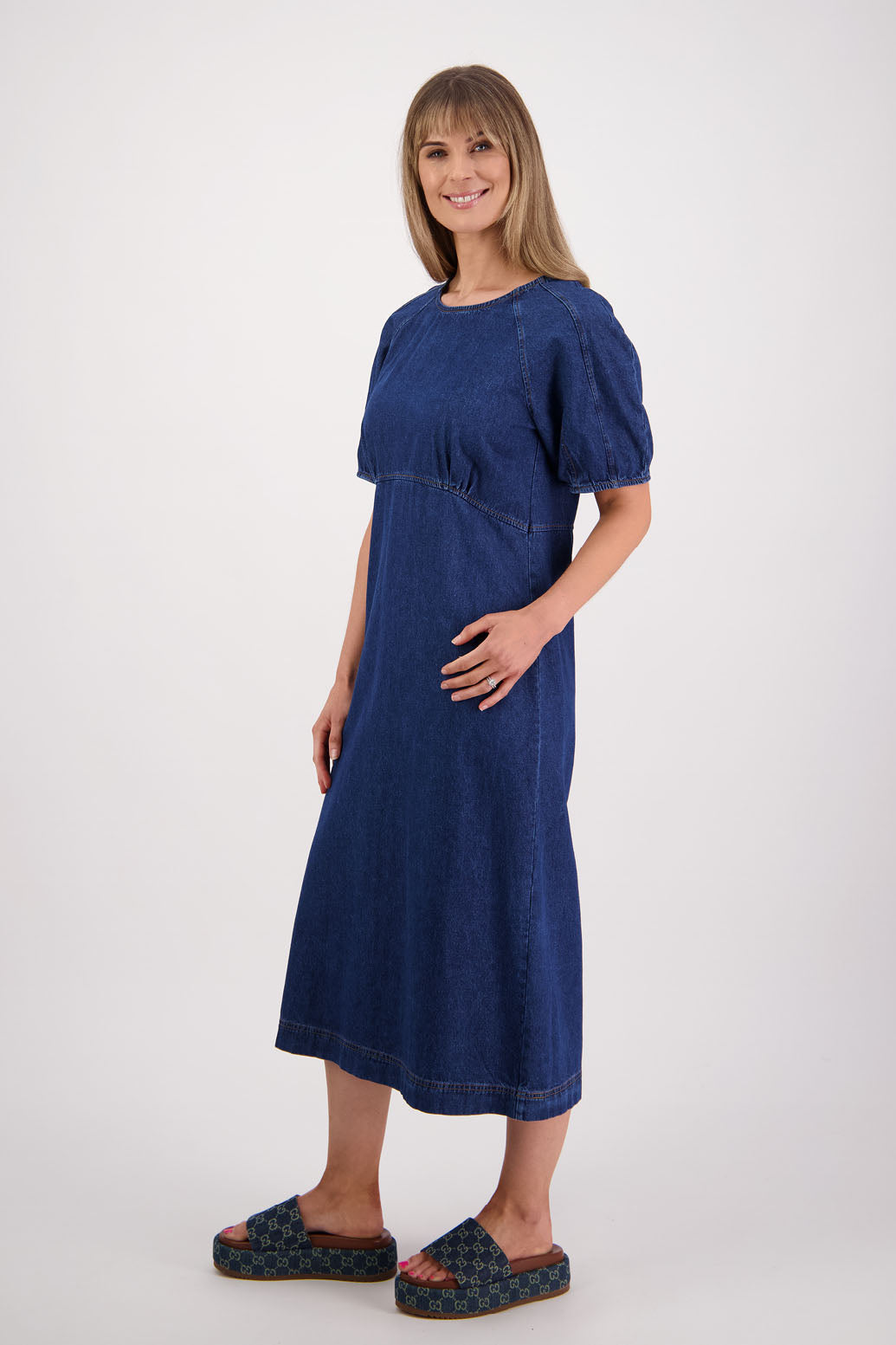 Womens denim dress, slim fitting body, curved empire line bodice and slight puff in panelled sleeves. Briarwood NZ
