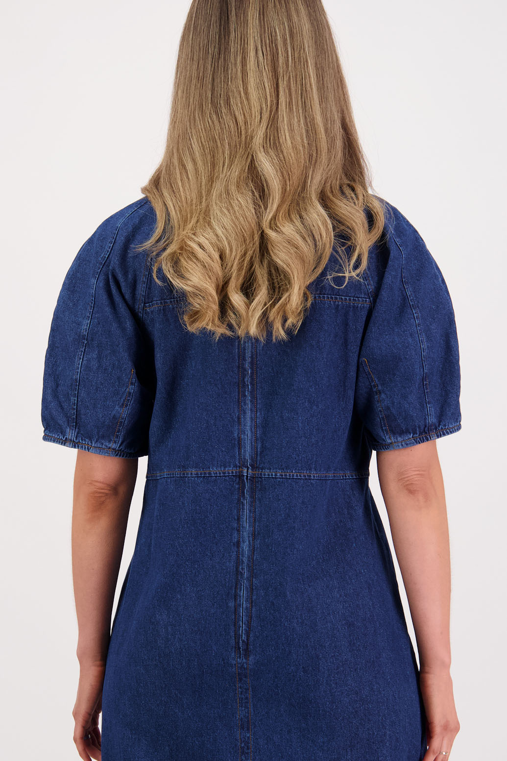Womens denim dress, slim fitting body, curved empire line bodice and slight puff in panelled sleeves. Briarwood NZ
