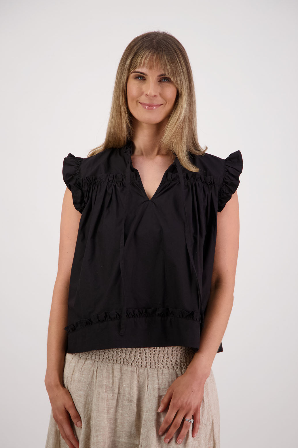 Womens black short sleeve wide top with V neck + tie, and small ruffle on the yolk, hem and sleeves. Briarwood NZ. Cotton Poplin. Skye