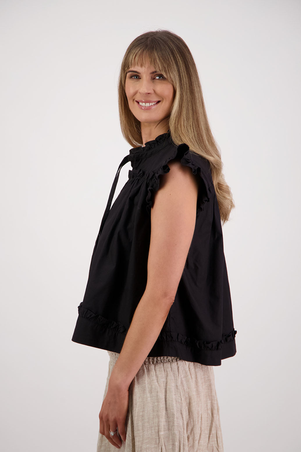 Womens black short sleeve wide top with V neck + tie, and small ruffle on the yolk, hem and sleeves. Briarwood NZ. Cotton Poplin. Skye