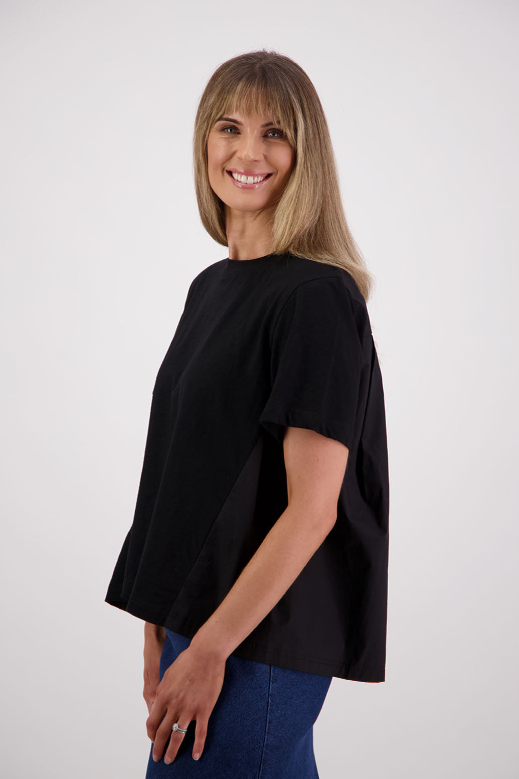 Womens oversized black cotton t-shirt with scooped neckline and swing back with cotton poplin pleat. Briarwood NZ. Smiley, Black