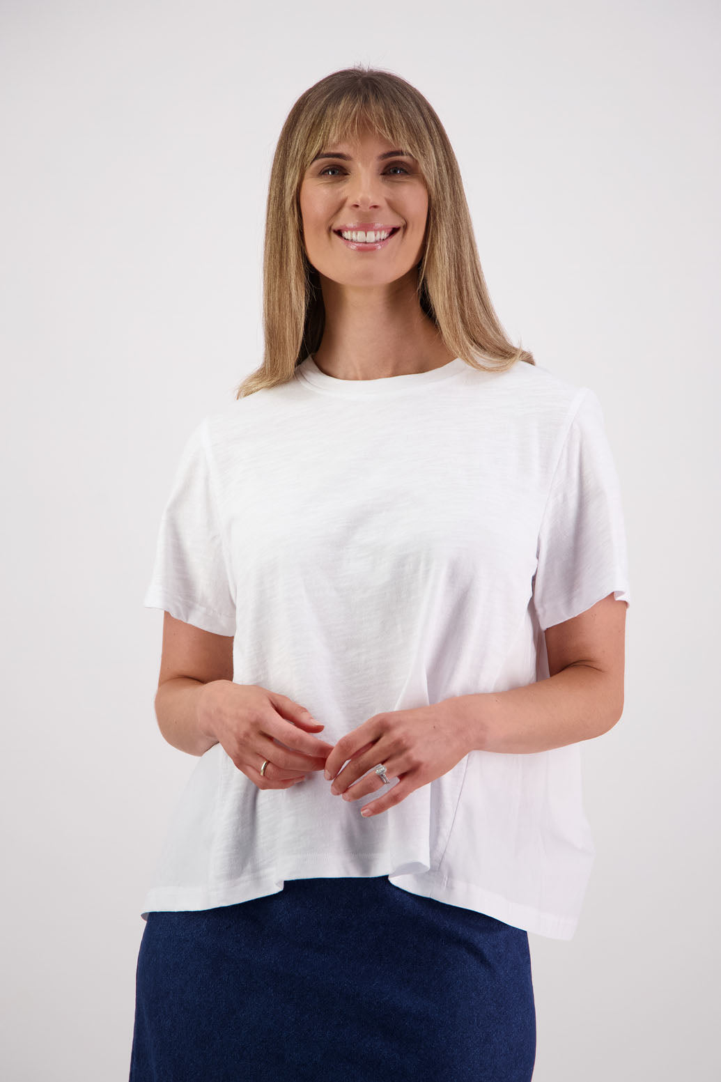Womens oversized black cotton t-shirt with scooped neckline and swing back with cotton poplin pleat. Briarwood NZ. Smiley, White