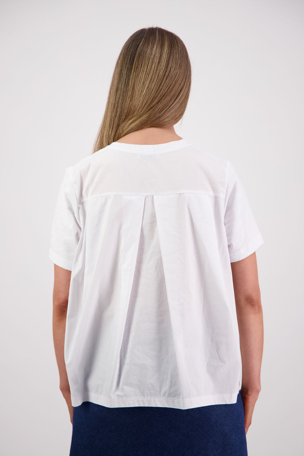 Womens oversized black cotton t-shirt with scooped neckline and swing back with cotton poplin pleat. Briarwood NZ. Smiley, White