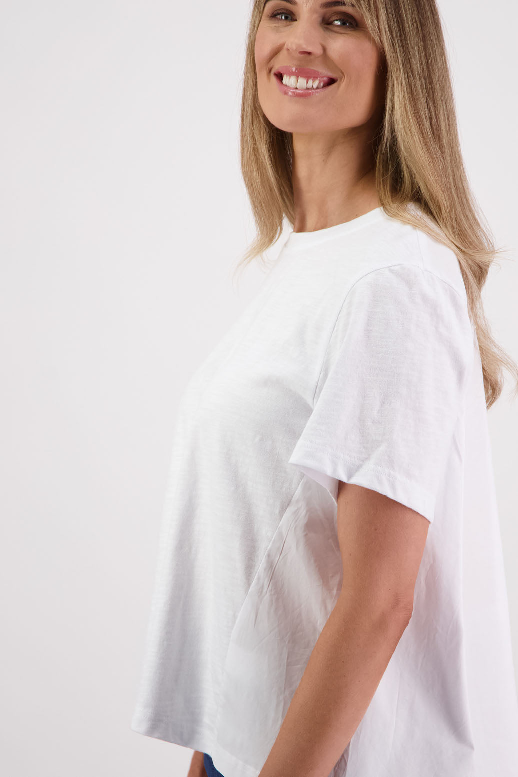 Womens oversized black cotton t-shirt with scooped neckline and swing back with cotton poplin pleat. Briarwood NZ. Smiley, White
