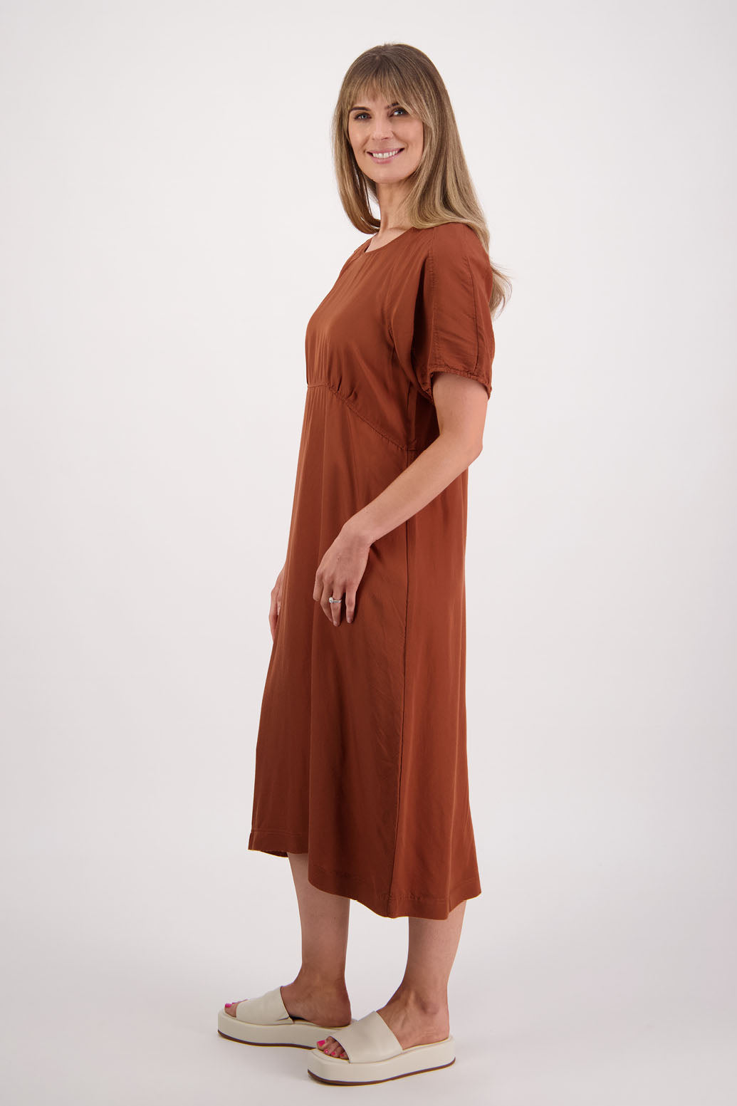 Womens tan dress with curved empire line bodice. Slim fitting body and midi length. Viscose. Briarwood NZ. Stacey