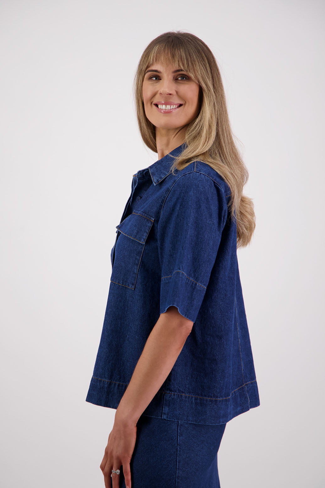 Womens box fit denim shirt with covered buttons, stitched on pockets and covered placket. Briarwood NZ. Syd