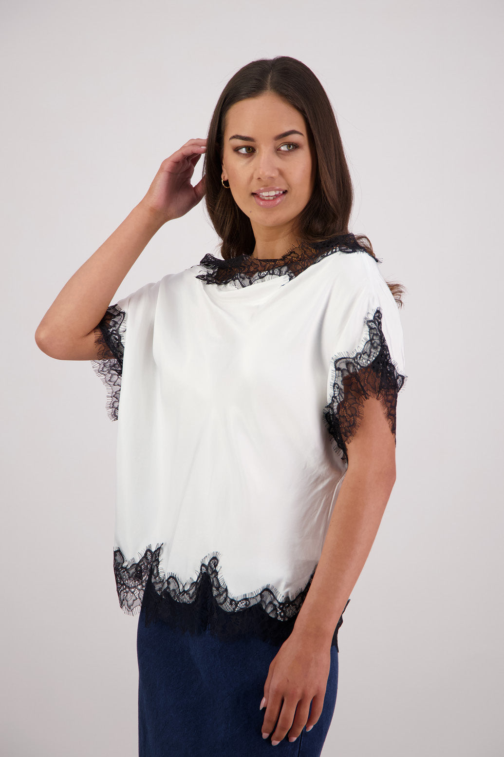 Side view Briarwood Tabby Top in a ivory, 100% viscose with black lace trims.