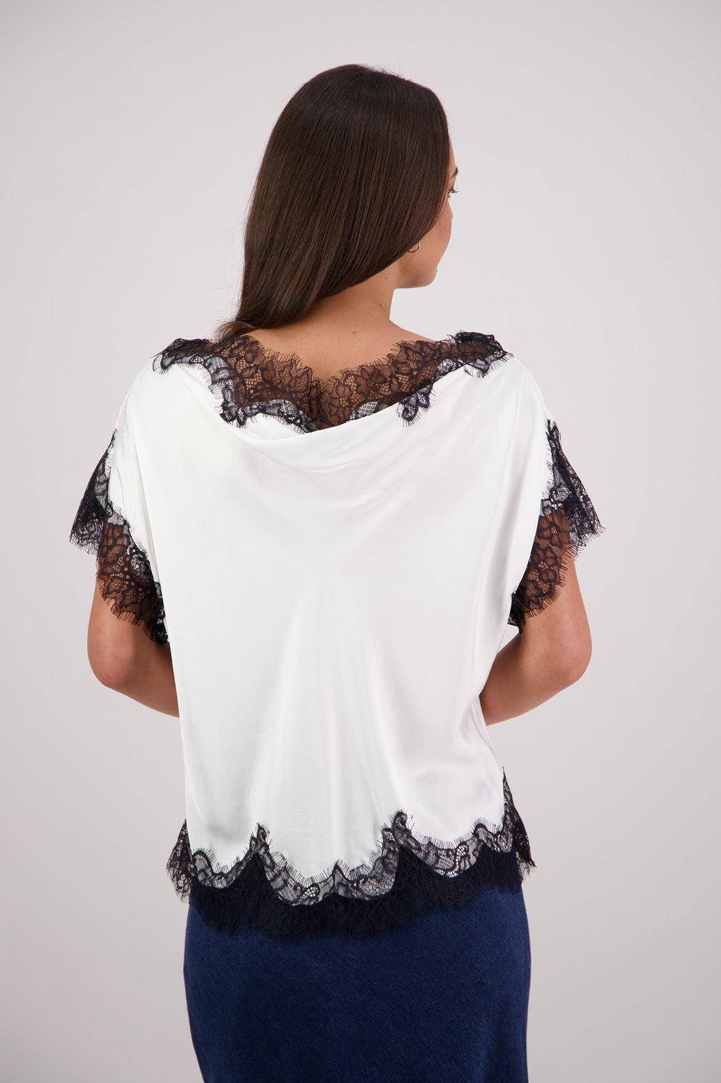 Back view Briarwood Tabby Top in a ivory, 100% viscose with black lace trims.