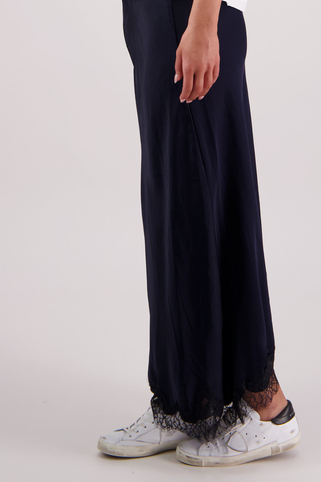 Closeup side view Briarwood Tallulah skirt in ink with black lace trim.