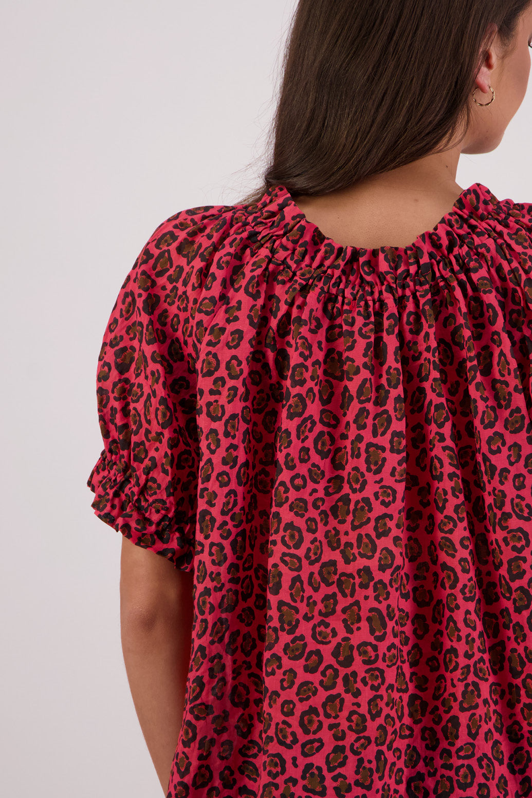 Closeup of back view of Briarwood Teddy Top in red animal print.