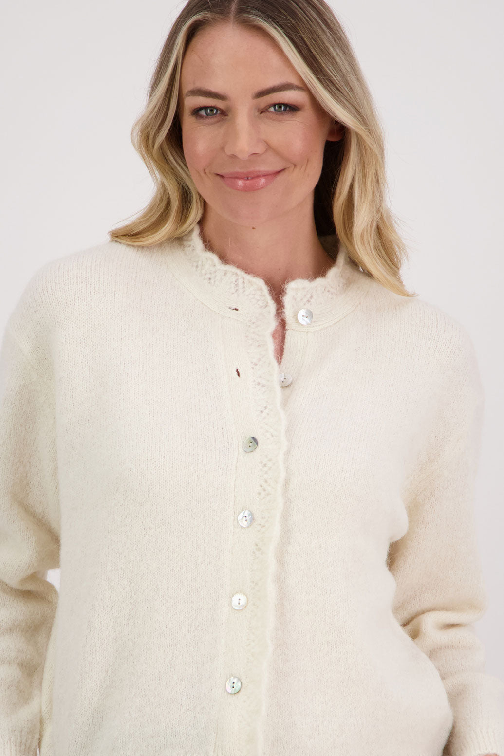 Ivory/Cream Briarwood cardigan with knitted lace trim around the neck and down the buttons.