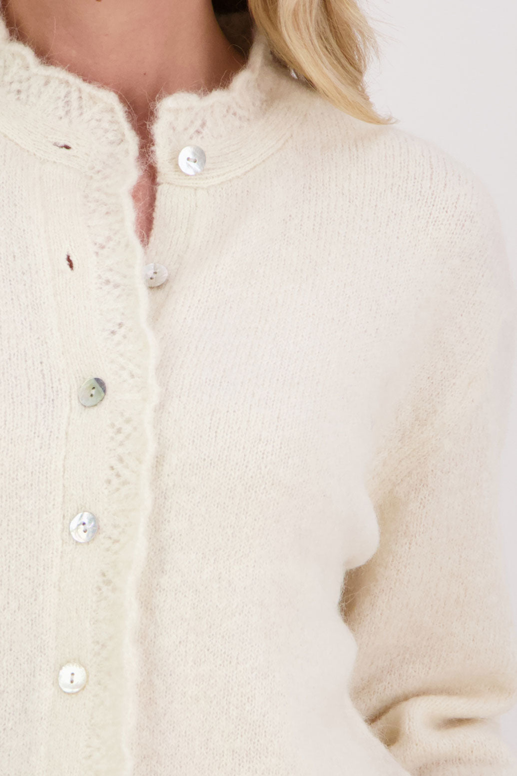 Ivory/Cream Briarwood cardigan with knitted lace trim around the neck and down the buttons.