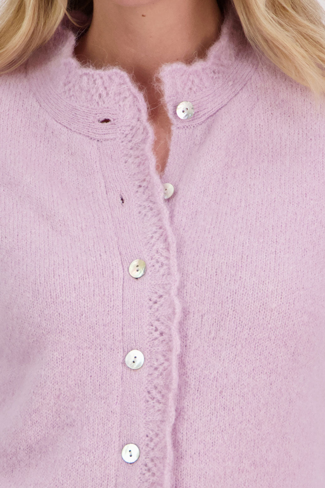 Pink/Mauve Briarwood cardigan with knitted lace trim around the neck and down the buttons.