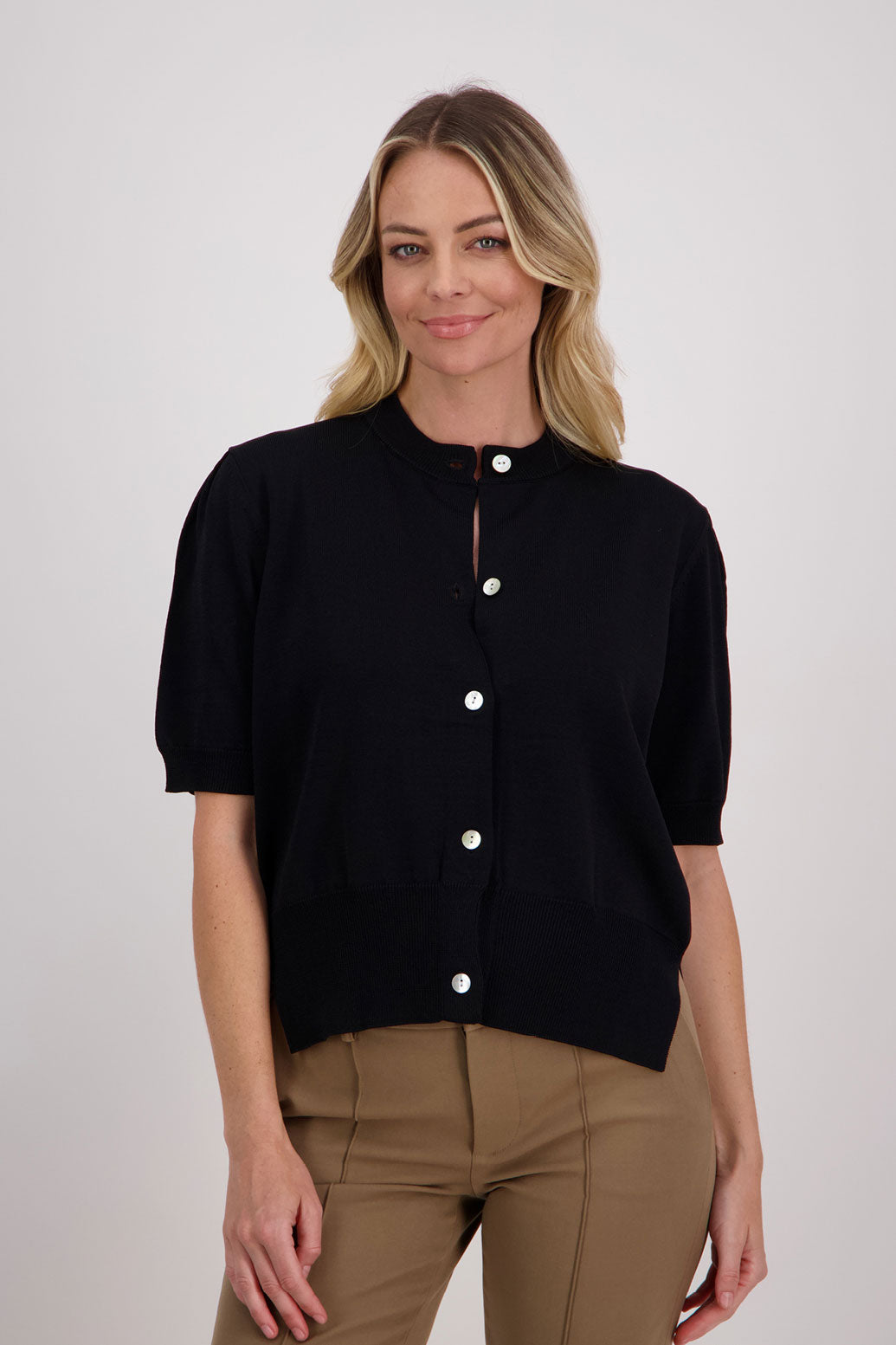 Classic black cardigan with elbow length sleeves, side split hem. Vera