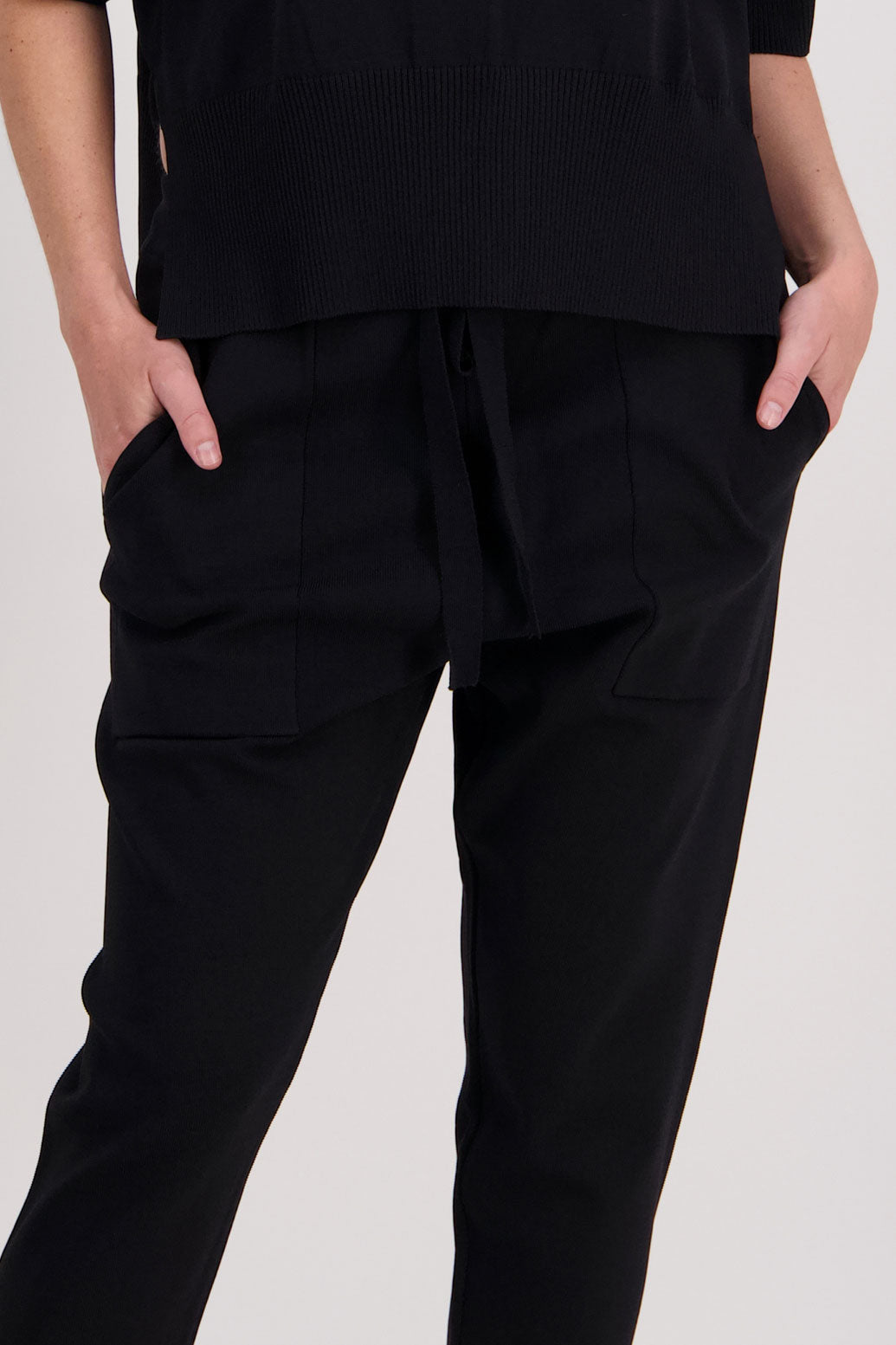 Black pant with a slight drop crotch, full length and patch pockets. Vogue